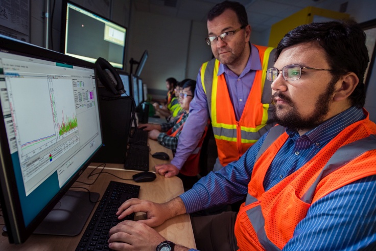 FRIB Front End Department Manager Eduard Pozdeyev reviews data with Graduate Student Michael Balcewicz in FRIB's control room. (Photo credit: Greg Kohuth/ Michigan State University)