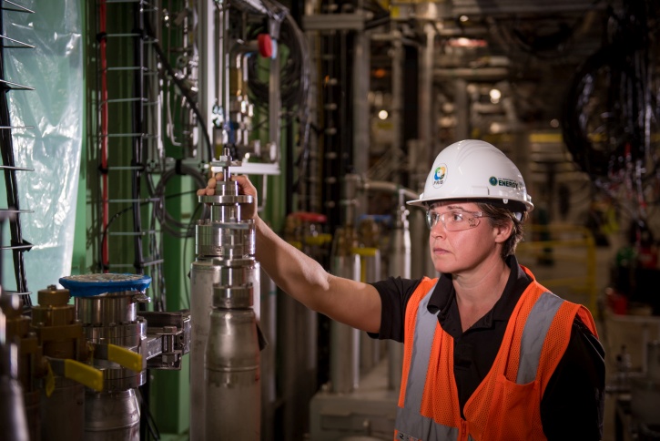 Shelly Jones, FRIB cryogenic fabrication group leader, inspects cryogenic equipment that is part of FRIB's linear accelerator.