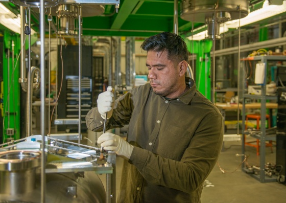 FRIB Graduate Student Crispin Contreras works on a superconducting radio frequency cavity in FRIB's processing facility.